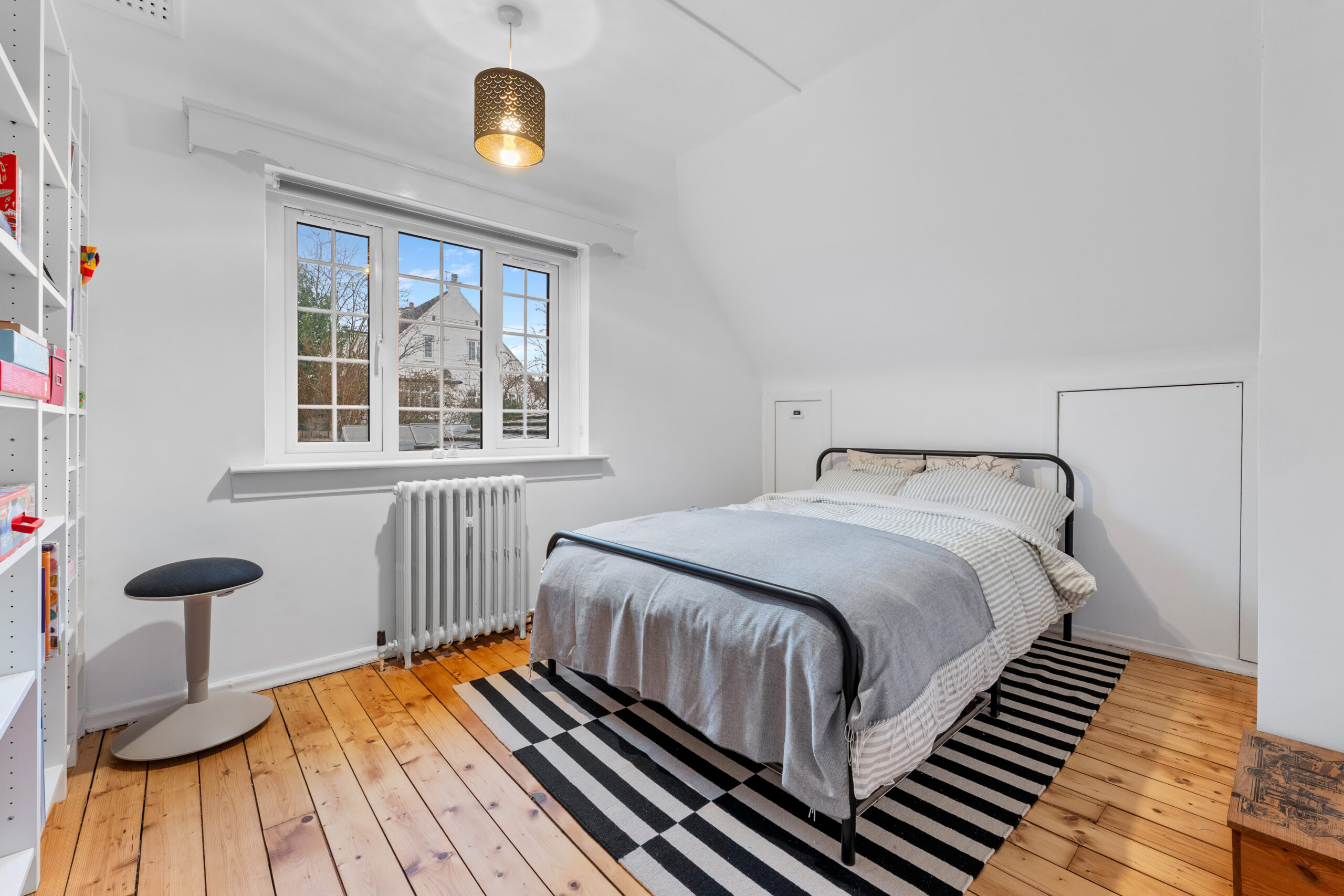 Bedroom with metal frame bed and shelving – Copy