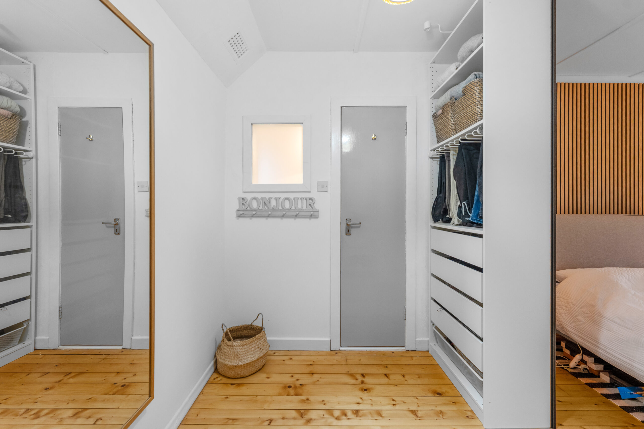 Dressing area to bedroom with wood panelling feature wal – Copy