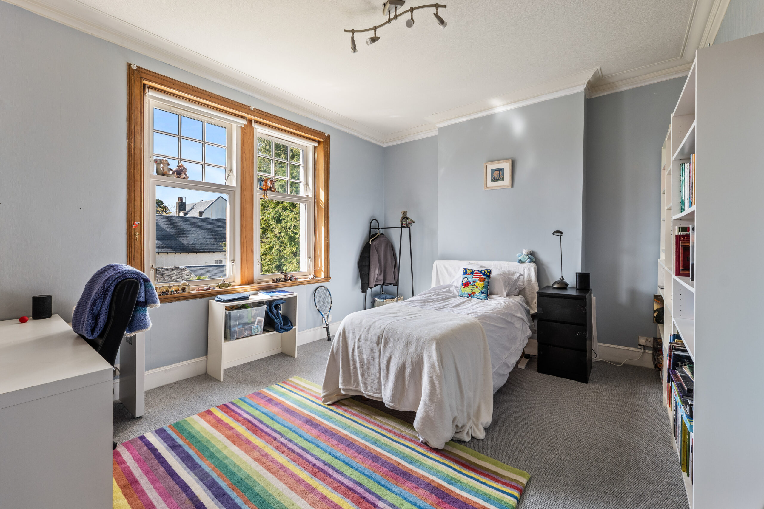 Bedroom with stripey rug