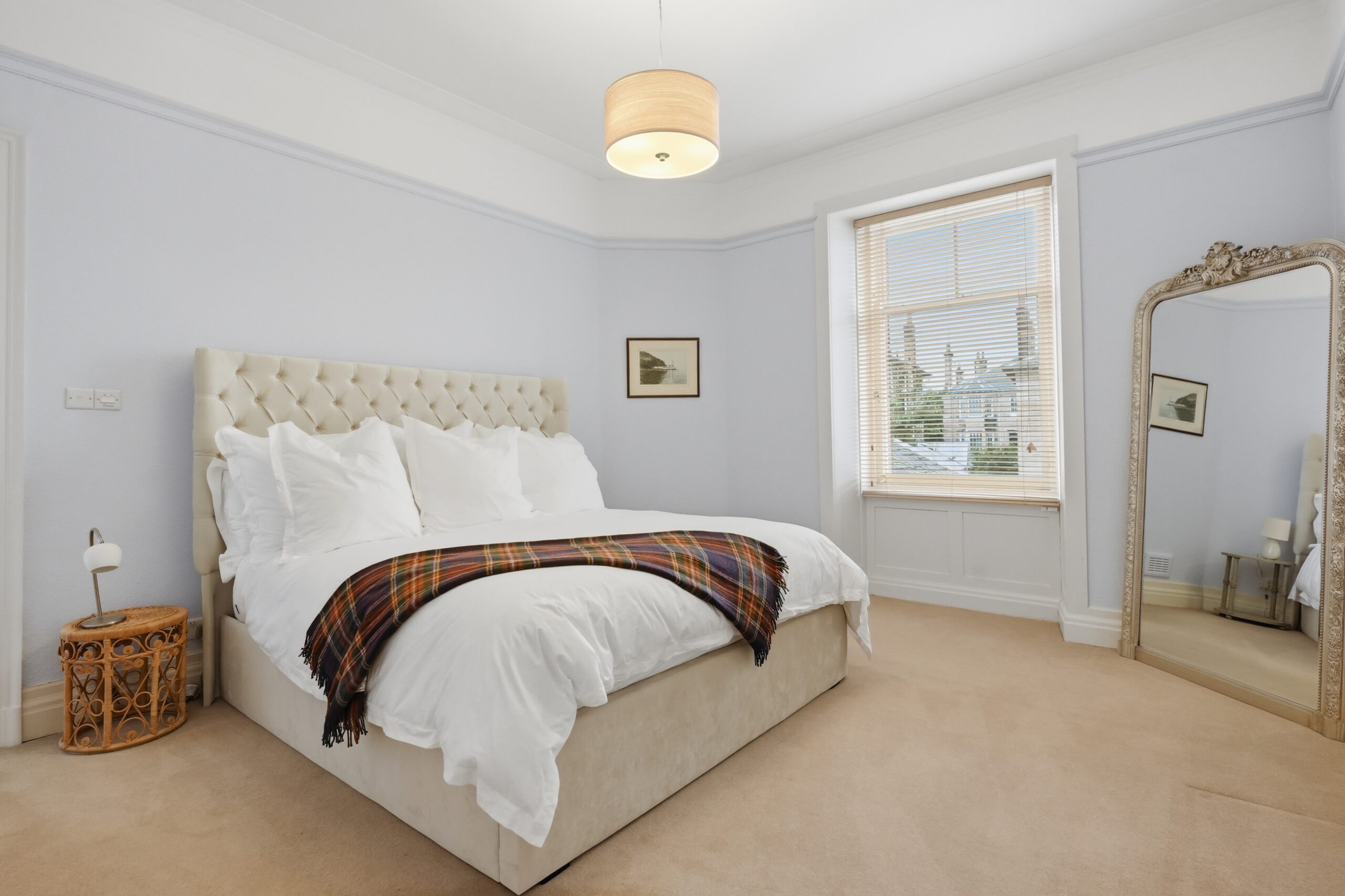 bedroom with tartan throw on bed